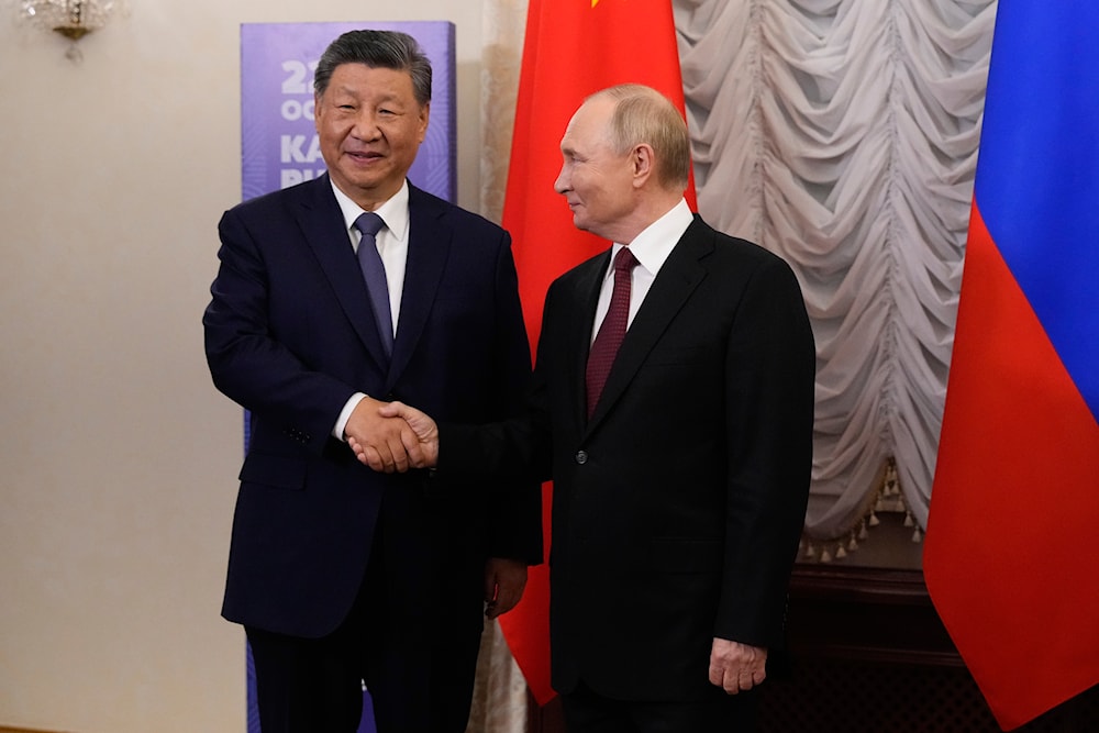 Russian President Vladimir Putin, right, and Chinese President Xi Jinping shake hands during their meeting on the sidelines of BRICS Summit at Kazan Kremlin in Kazan, Russia, Tuesday, Oct. 22, 2024.