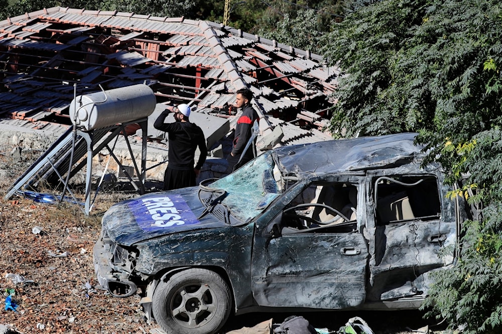 People observe the site where an Israeli airstrike hit a compound housing journalists in Hasbaya village, southeast Lebanon, Friday, October 25, 2024 (AP)