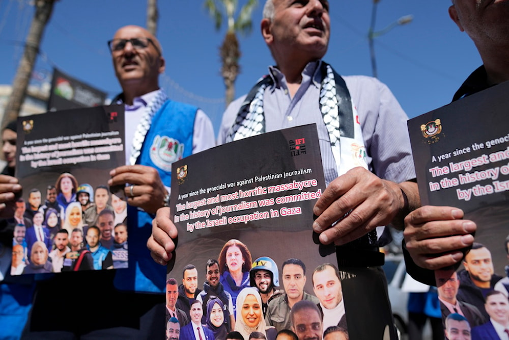 Palestinian journalists hold posters during a protest ahead of the one year anniversary of the war on Gaza, in the West Bank city of Ramallah Sunday, Oct. 6, 2024. (AP)