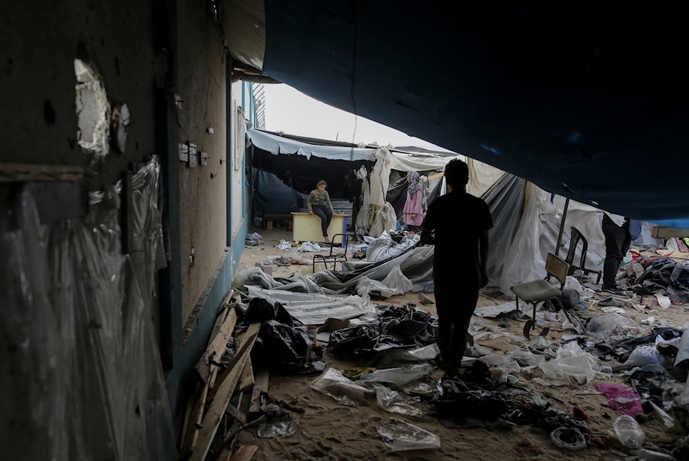 Displaced Palestinians inspect their tents destroyed by Israel's bombardment, adjunct to an UNRWA facility west of Rafah city, Gaza Strip, Tuesday, May 28, 2024.