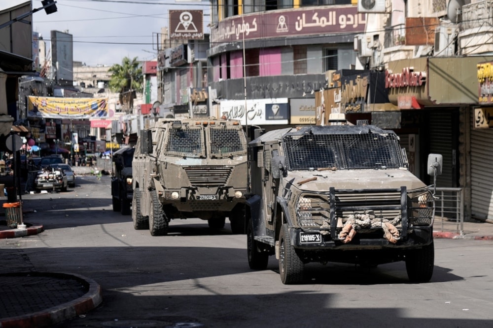 Israeli occupation army jeeps move into the West Bank city of Nablus during a raid, on September 22, 2024. (AP)