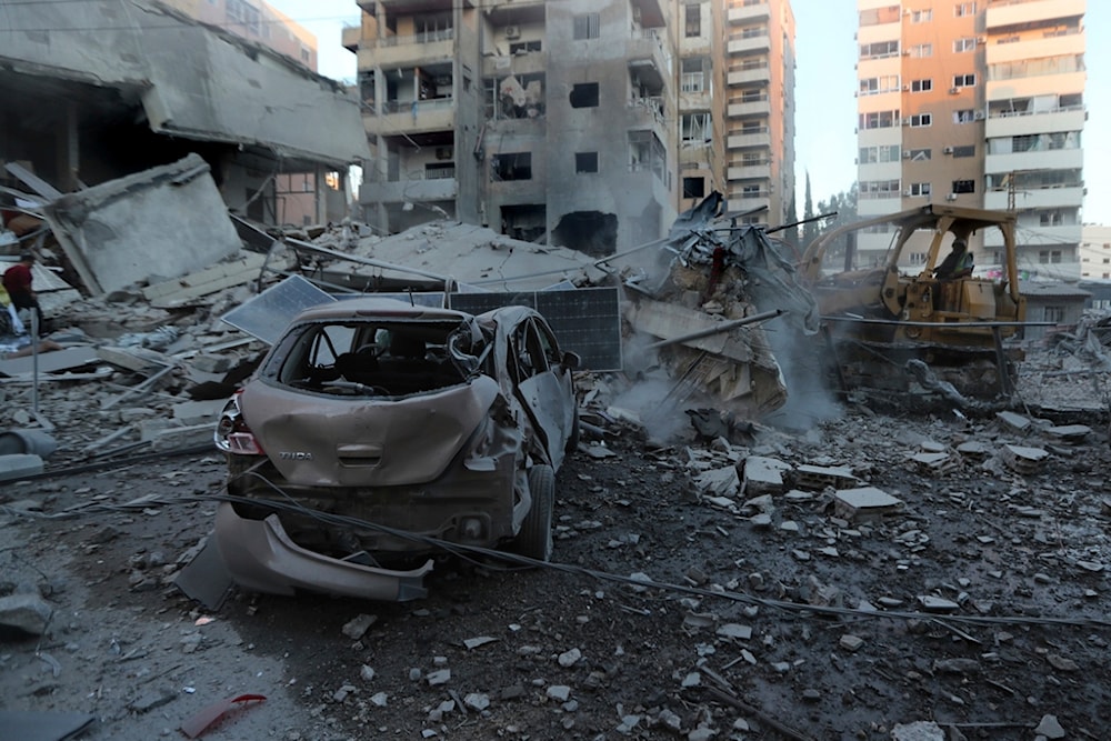 A rescue worker uses a bulldozer to remove the debris of destroyed buildings hit in Israeli occupation airstrikes in Tyre, Lebanon, Monday, Oct. 28, 2024. (AP)