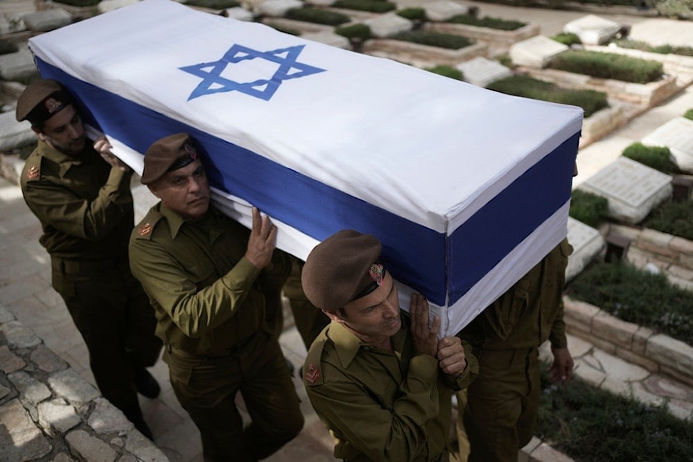 Soldiers from an IOF honor guard march with the coffin of Sergeant Major (res.) Mordechai Haim Amoyel, who was killed in action in Lebanon, during his funeral at Mount Herzl military cemetery in occupied al-Quds, occupied Palestine, October 25, 2024 (AP)