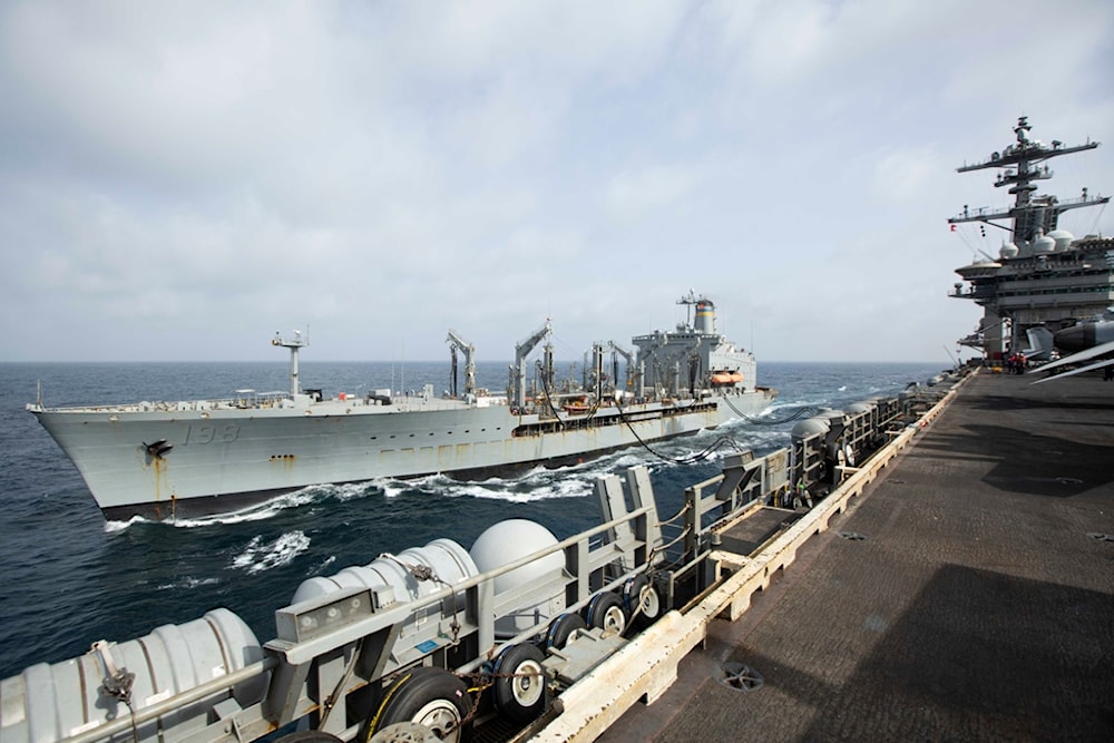 This handout photo from the U.S. Navy shows the Henry J. Kaiser-class fleet replenishment oiler USNS Big Horn sailing alongside the aircraft carrier USS Abraham Lincoln on September 11, 2024, at an undisclosed location at sea in the Middle East (AP)