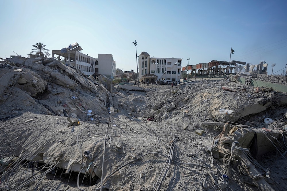 Palestinians inspect the rubble of a school destroyed in an Israeli airstrike on Deir al-Balah, central Gaza Strip, Saturday, July 27, 2024. (AP Photo/Abdel Kareem Hana)