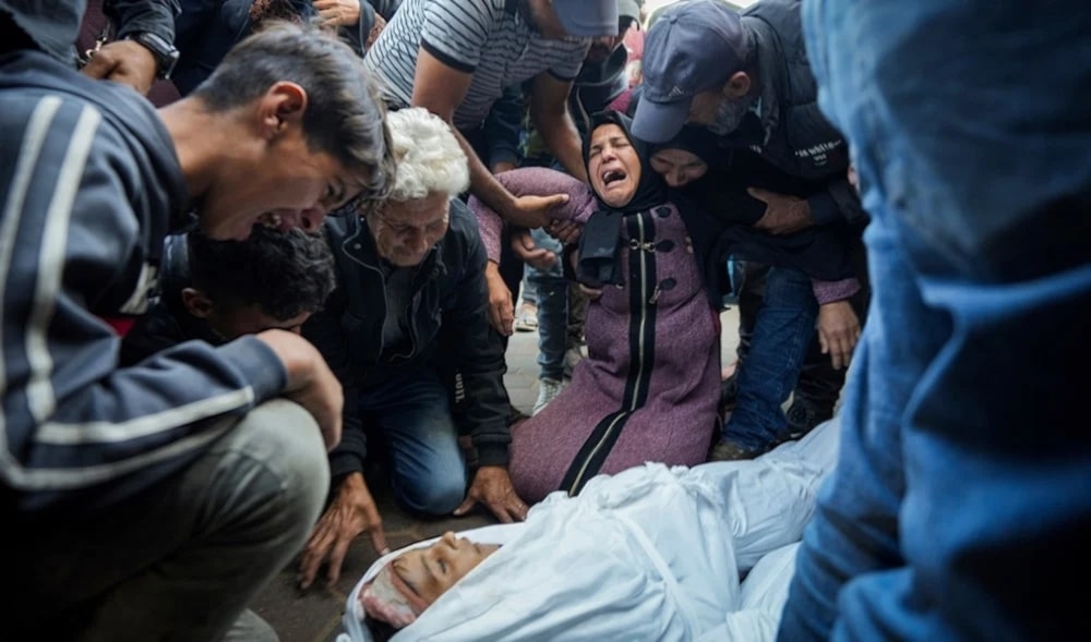 Palestinian mourn their relatives killed in the Israeli bombardment of the Gaza Strip at a hospital morque in Deir al-Balah,Tuesday,October 29,2024. (AP)