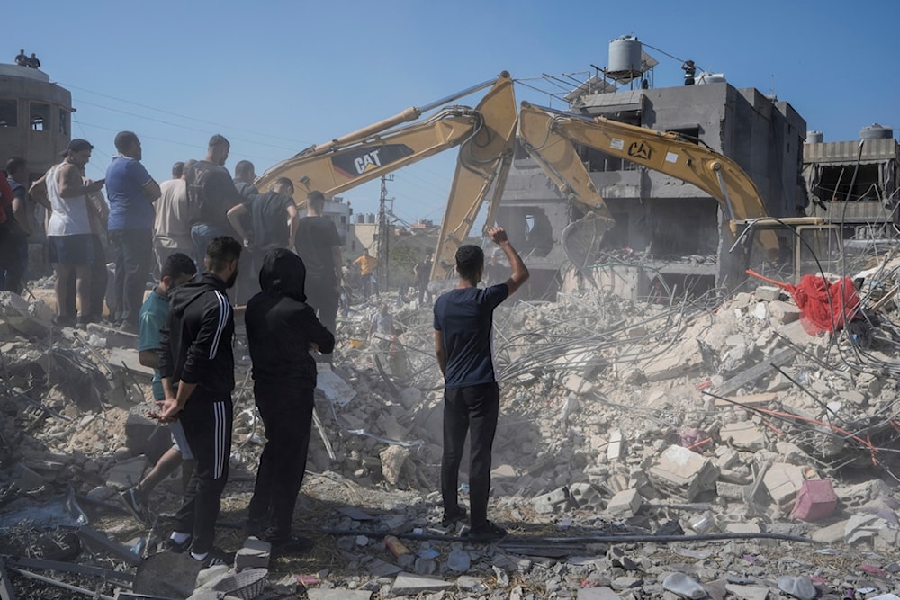 Rescue workers use excavators to remove the rubble of a destroyed building that was hit Tuesday night in an Israeli airstrike, as they search for victims in Sarafand, south Lebanon, Wednesday, Oct. 30, 2024. (AP)