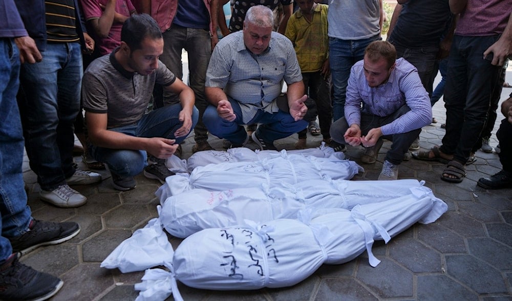 Palestinians mourn their relatives, including kids killed in the Israeli bombardment of the Gaza Strip, outside a morgue in Deir al-Balah, Gaza, Monday, Sept. 23, 2024. (AP)