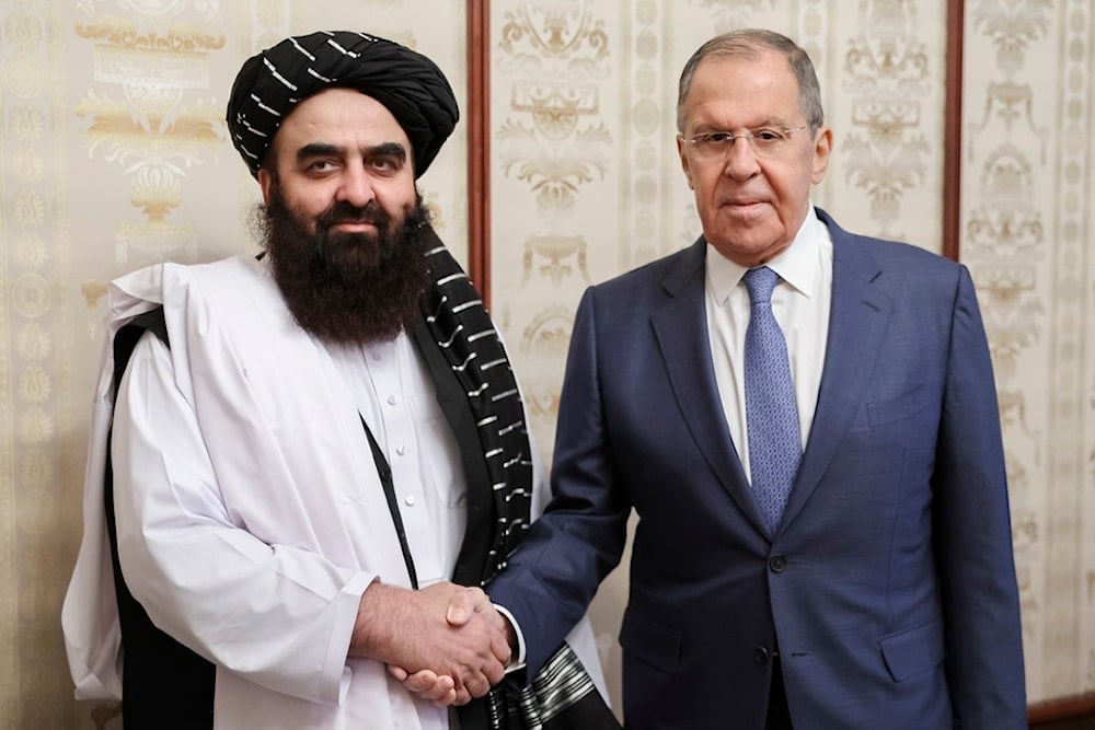 Russian Foreign Minister Sergey Lavrov, right, and Acting Foreign Minister of Afghanistan's Taliban movement Amir Khan Muttaqi pose for a photo prior to their talks in Moscow, Russia, Oct. 4, 2024 (Russian Foreign Ministry Press Service via AP)