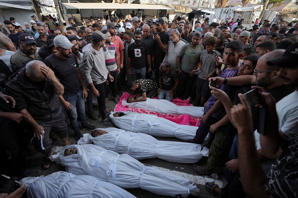 Mourners gather around the bodies of Palestinian men who were killed in an Israeli airstrike in Deir al-Balah, Gaza, Sunday, Oct. 6, 2024. (AP)