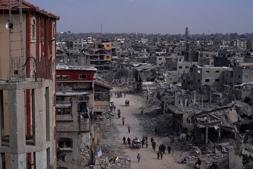 Palestinians walk through the destruction in the wake of an Israeli air and ground aggression on Khan Younis, southern Gaza Strip, on April 8, 2024. (AP)