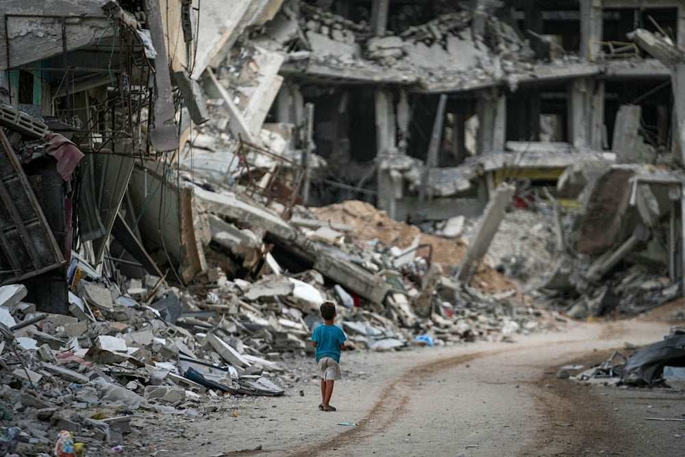 A child walks through the destruction left by the Israeli aggression on Khan Younis, Gaza Strip, September 12, 2024. (AP)