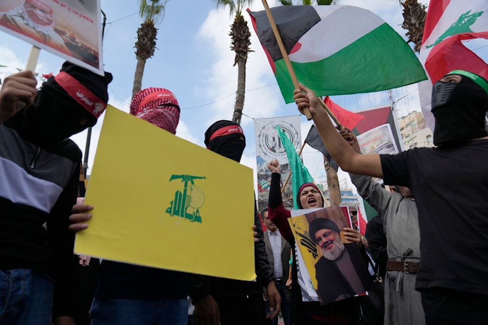 Palestinian activists chant slogans during a protest marking the one year anniversary of Operation Al-Aqsa Flood, in the West Bank city of Ramallah, Monday, Oct. 7, 2024. (AP)