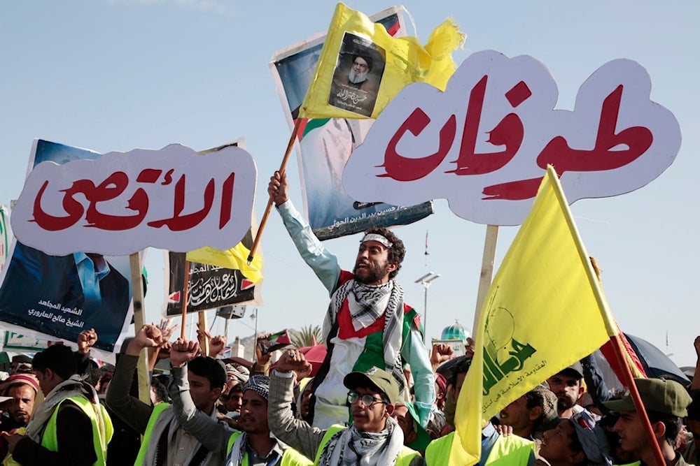 Yemenis raise Hezbollah flags and posters of its martyred leader Sayyed Hassan Nasrallah during a rally to commemorate the first anniversary of Operation Al-Aqsa Flood, in Sanaa, Yemen, Monday, Oct. 7, 2024. (AP)