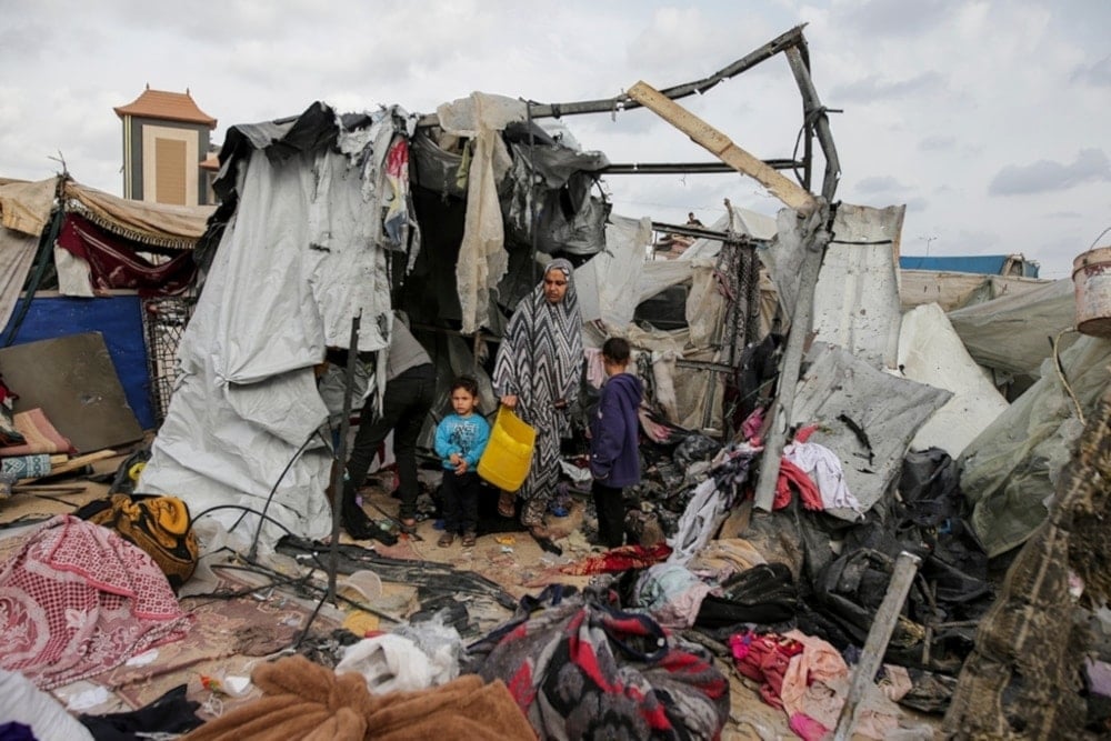 Displaced Palestinians inspect their tents destroyed by Israeli bombardment, adjunct to an UNRWA facility west of Rafah city, Gaza Strip, Tuesday, May 28, 2024. (AP)