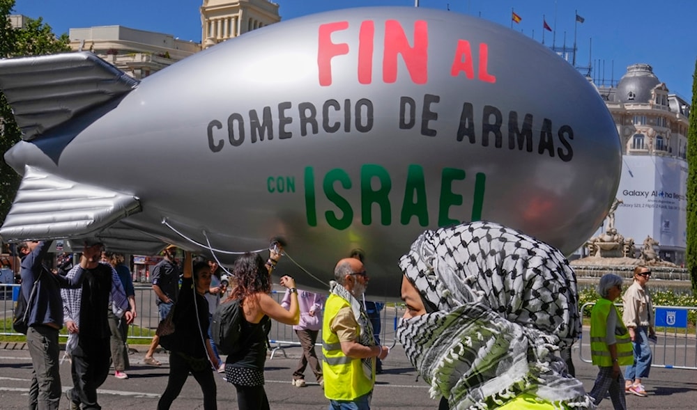 A blimp with the massage ' Stop the arms sales to Israel' is carried during a demonstration to show solidarity with Palestinians during a protest march in Madrid, Spain, April 21, 2024. (AP)