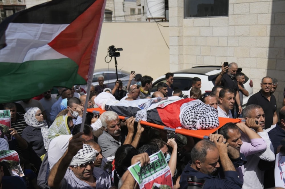 Palestinian mourners carry the body of Aysenur Ezgi Eygi who was fatally shot by Israeli soldiers while participating in an anti-settlement protest in the West Bank during her funeral procession in the West Bank city of Nablus, on September 9, 2024. (AP)