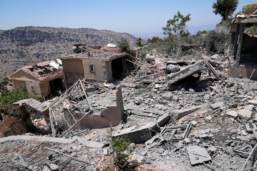 A civil defense worker inspects destroyed houses that were hit by an Israeli airstrike, in Chebaa, a Lebanese town near the border with occupied Palestine, south Lebanon, June 26, 2024. (AP)