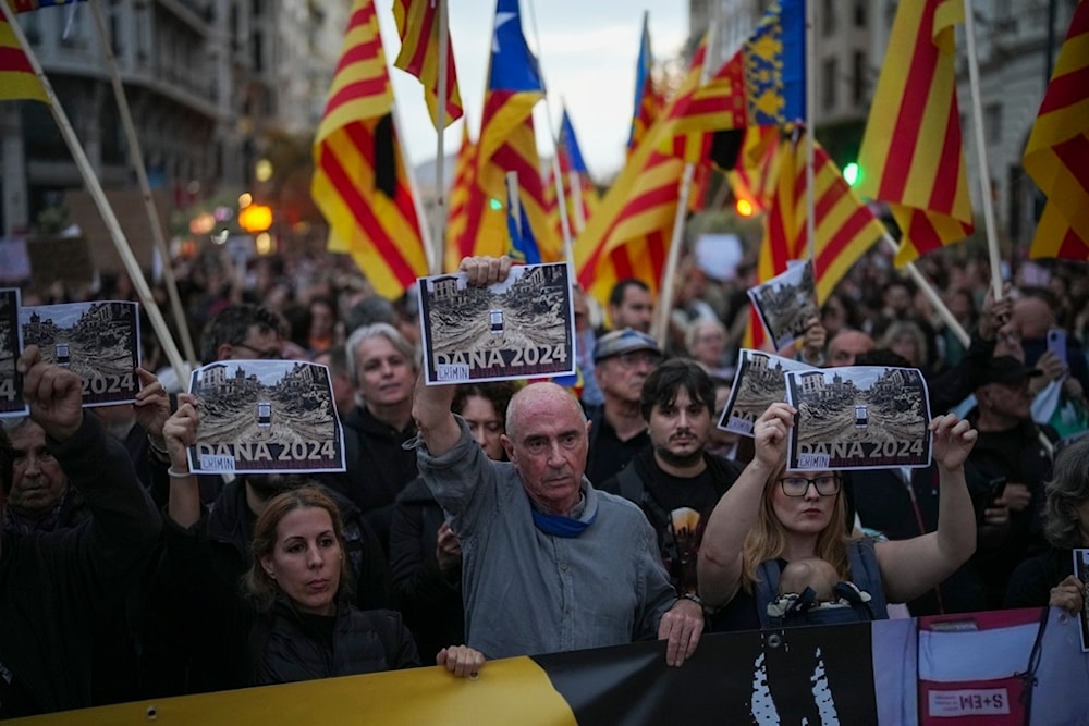 Demonstrators gather for a protest organized by social and civic groups, denouncing the handling of recent flooding under the slogan 