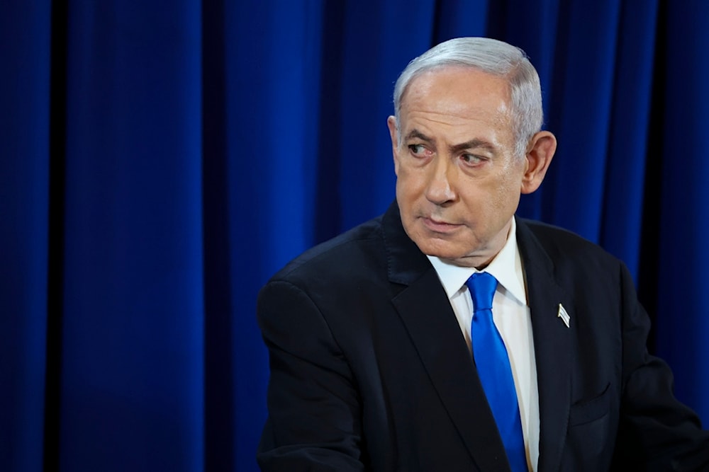 Israeli Prime Minister Benjamin Netanyahu pauses during a press conference in Tel Aviv, occupied Palestine, Saturday July 13, 2024. (Nir Elias/Pool Photo via AP)