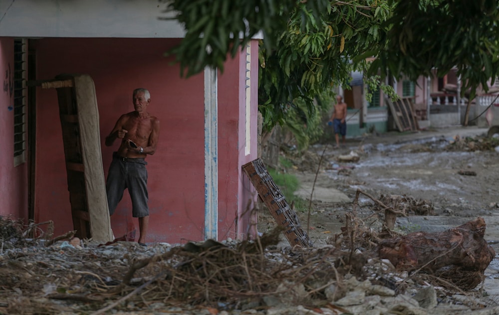 A local looks at a drying mattress after Hurricane Oscar hit the town of Imias in Guantanamo province, Cuba, on October 30, 2024. (AP)