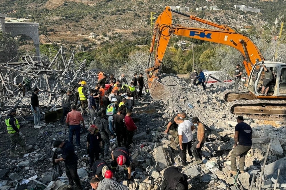 Rescuers use an excavator to search for survivors at the site of an Israeli airstrike that targeted the village of Almat north of Beirut on November 10, 2024 ( AFP)