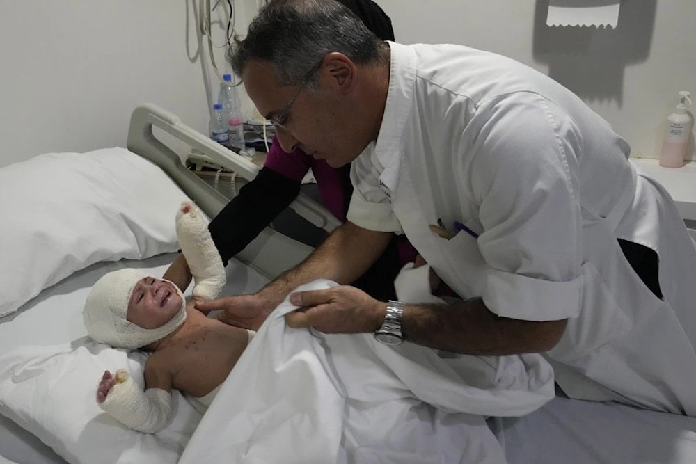 Plastic surgeon doctor Ziad Sleiman, inspects Ivana Skakye, 2, as she lies on a bed at the Geitaoui hospital where she is receiving treatment, in Beirut, Lebanon, Tuesday, Oct. 29, 2024. (AP)