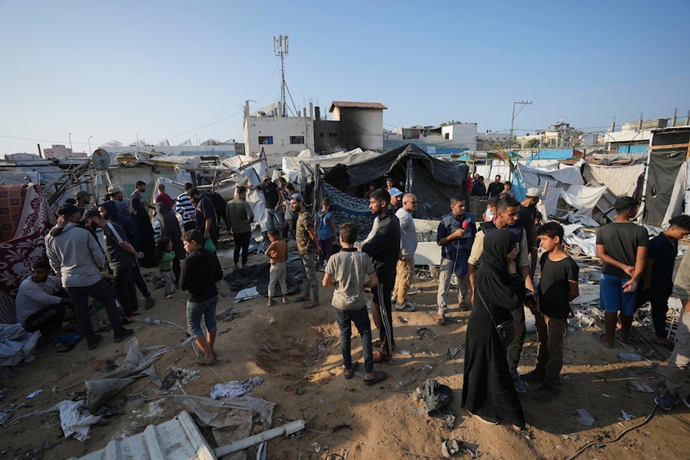 Palestinians gather at the site of an Israeli strike in the courtyard of the Al-Aqsa Hospital where displaced people live in tents, in Deir al-Balah, Gaza Strip, on November 9, 2024. (AP)