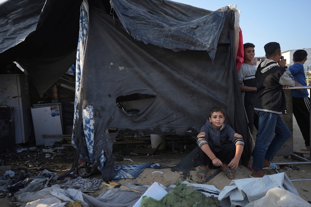 Palestinians gather at the site of an Israeli strike in the courtyard of the al-Aqsa Hospital where displaced people live in tents, in Deir al-Balah, Gaza Strip, Saturday, November 9, 2024. (AP)