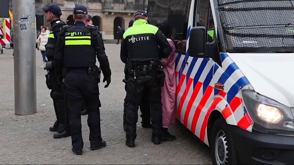 Police detain a person next to the place where Maccabi Tel Aviv supporters gather ahead of the Europa League soccer match between their team and Ajax, in Amsterdam, the Netherlands, Thursday, Nov. 7, 2024. (AP)