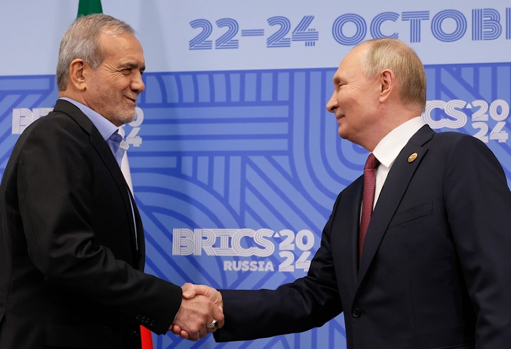 Russian President Vladimir Putin, right, and Iranian President Masoud Pezeshkian shake hands during their meeting on the sidelines of the BRICS summit in Kazan, Russia, Wednesday, Oct. 23, 2024. (AP)