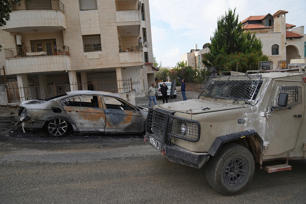 Israeli army investigators arrive at the site of the early morning attack of Israeli settlers, that left at least 18 burnt vehicles, on the outskirts of the West Bank city of al-Bireh on November 4, 2024. (AP)