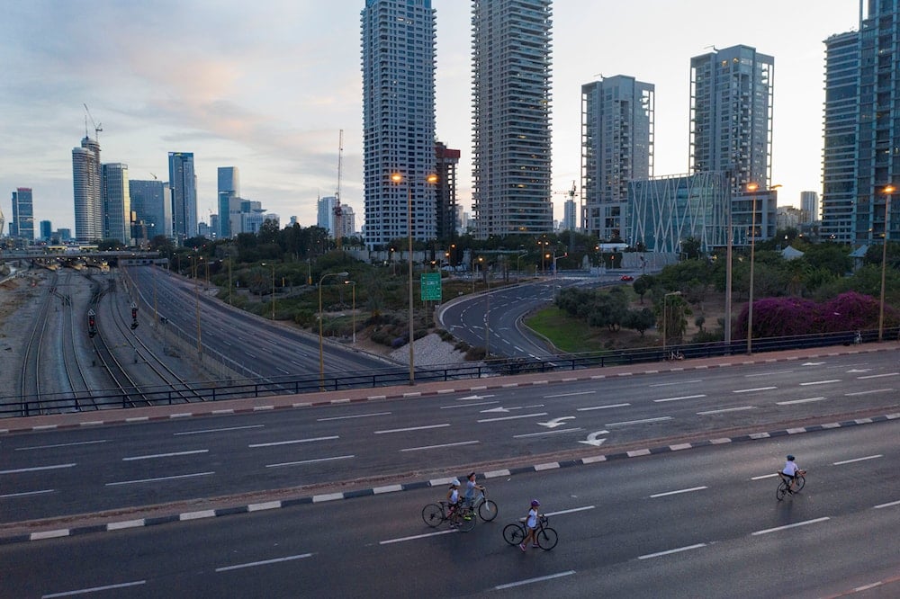 People ride their bicycles on a car-free highway during the Jewish holiday of Yom Kippur in 'Tel Aviv', occupied Palestine, on October 8, 2019. (AP)