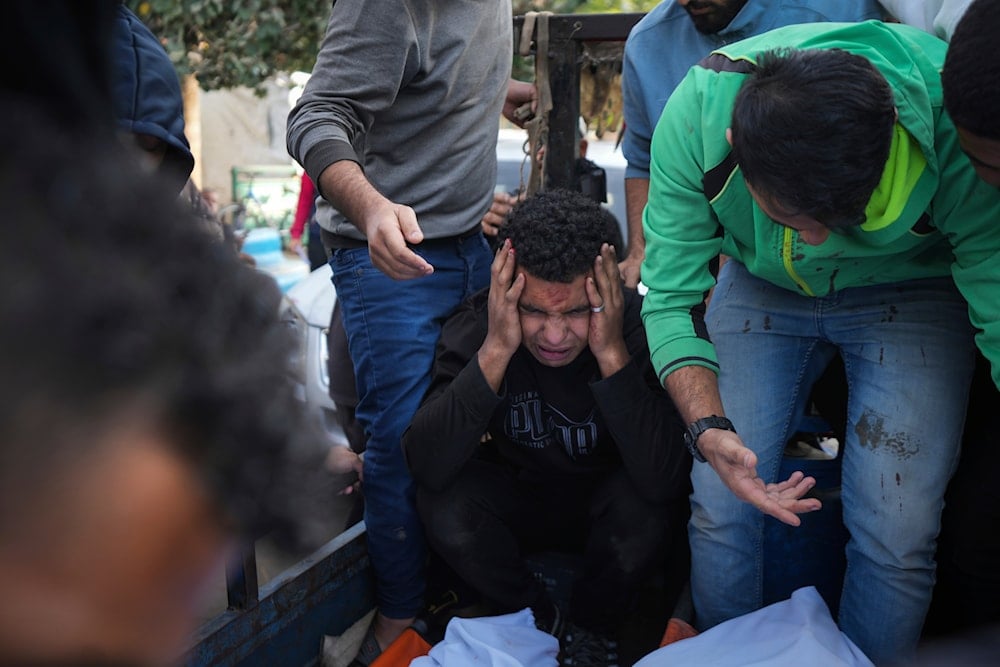 Palestinians mourn their relatives killed in the Israeli bombardment of Maghazi in the Gaza Strip, during their funeral at a hospital morgue in Deir al-Balah, Gaza, on November 14, 2024. (AP)