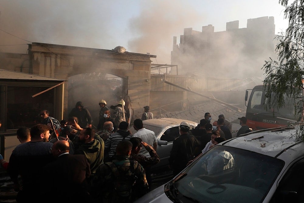 Security officers and rescuers gather at a destroyed building hit in an Israeli airstrike in Damascus, Syria, Thursday, Nov. 14, 2024. (AP)