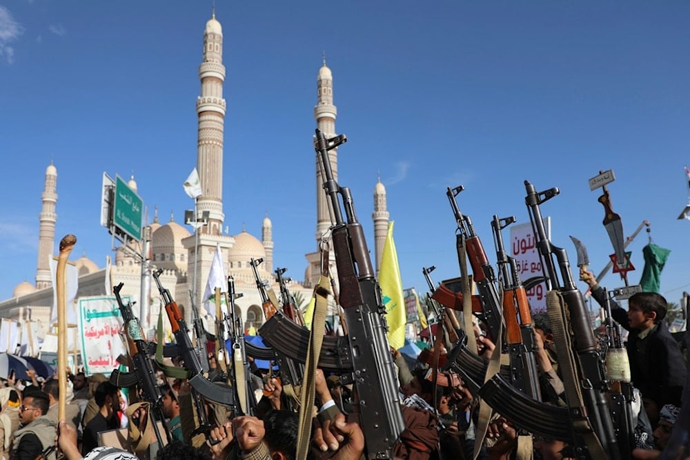 Yemenis raise their machine guns during an anti-US and Israeli rally in Sanaa, Yemen, Friday, November 1, 2024 (AP)