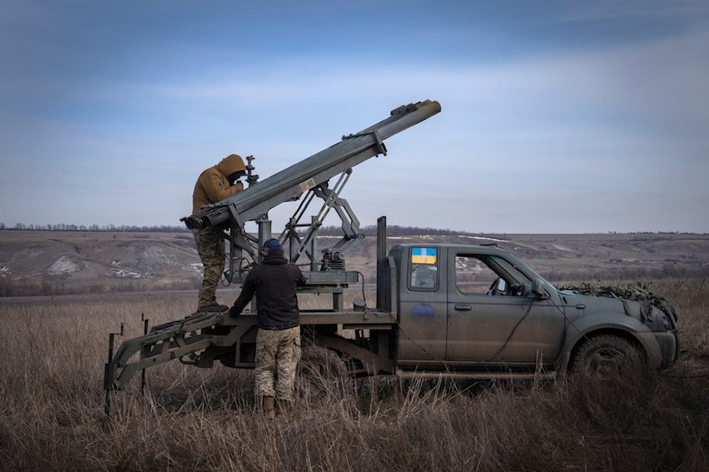 Ukrainian soldiers prepare to fire a multiple launch rocket system based on a pickup truck towards Russian positions at the front line, near Bakhmut, Donetsk region, Ukraine, March 5, 2024. (AP)