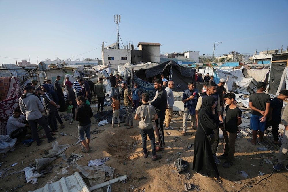 Palestinians gather at the site of an Israeli strike in the courtyard of the Al-Aqsa Hospital where displaced people live in tents, in Deir al-Balah, Gaza Strip, Saturday, Nov. 9, 2024. (AP)