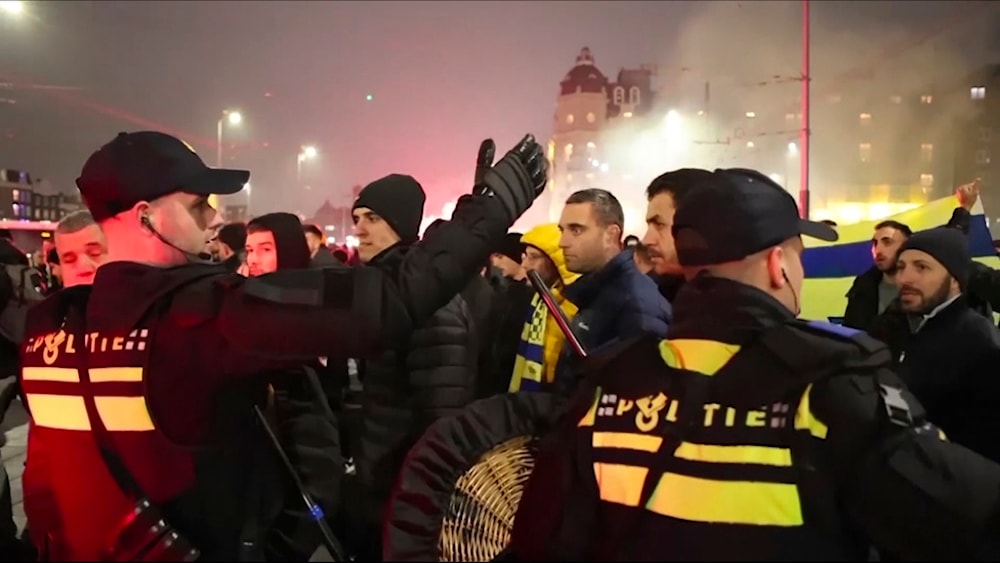 Police escort Maccabi Tel Aviv supporters to the metro station leading to the Ajax stadium, after pro-Palestinian supporters marched near the stadium, in Amsterdam, Netherlands, Nov. 7, 2024. (AP)