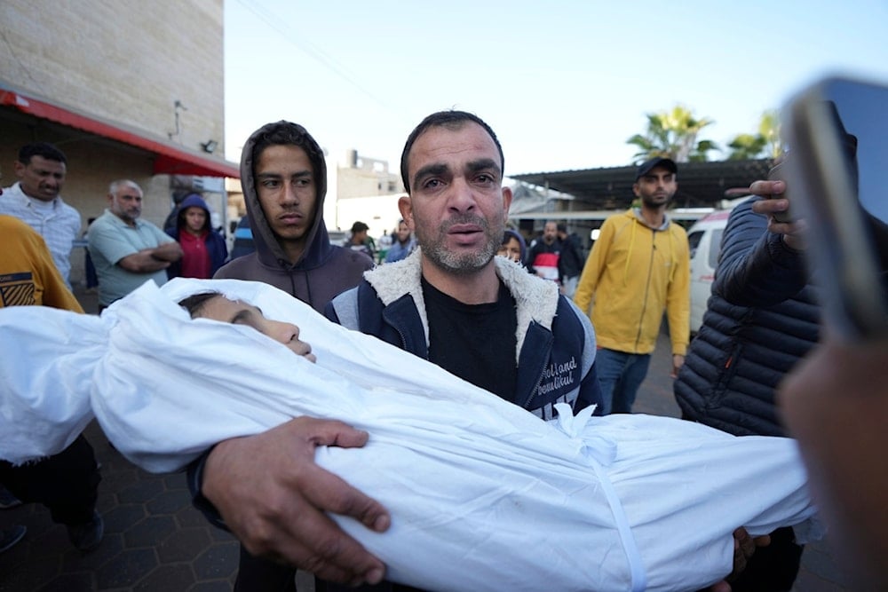 A Palestinian mourns a child, one of of nine people killed in an Israeli strike in Bureij refugee camp, Gaza Strip, Friday, Nov. 15, 2024. (AP)