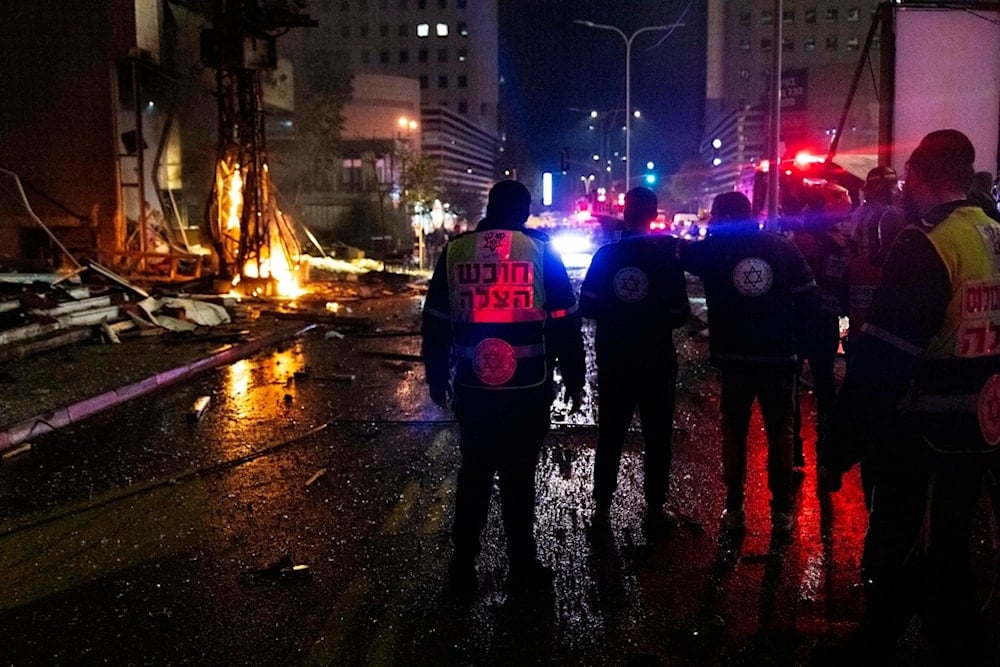 Security forces cordon and inspect the location of a rocket attack in Ramat Gan, Tel Aviv District, occupied Palestine, Monday, November 18, 2024 (AP)