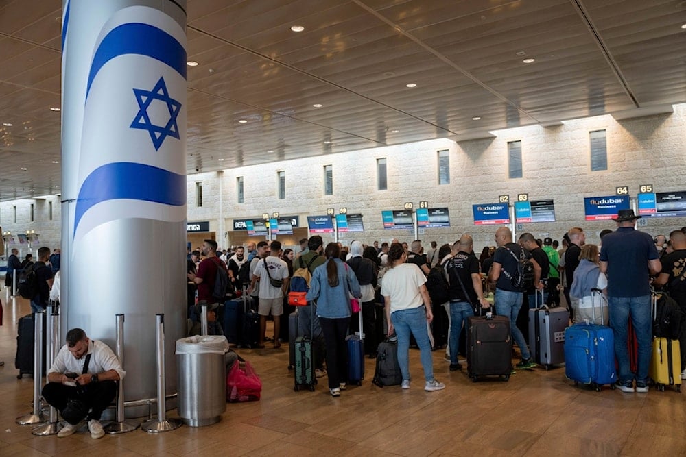 Travelers line up for check at Fly Dubai airline counter at Ben Gurion International Airport in al-Lydd, occupied Palestine, Sunday, November 10, 2024 (AP) 