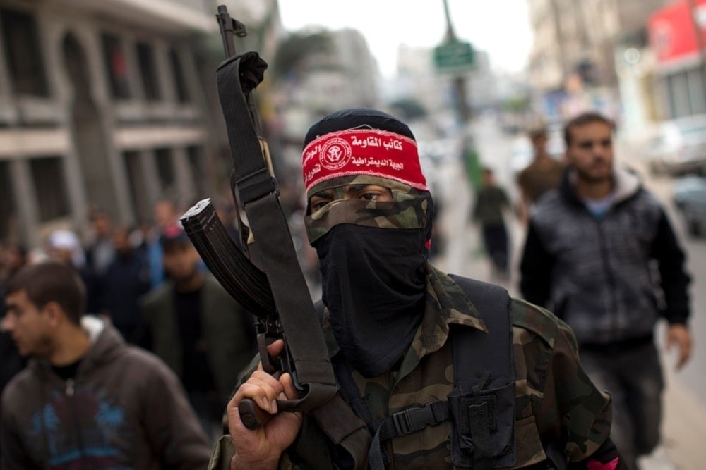 A National Resistance Brigades fighter from the Democratic Front for the Liberation of Palestine (DFLP) attends the funeral procession in, Gaza City, the Gaza Strip, on November 22, 2012 (AP)