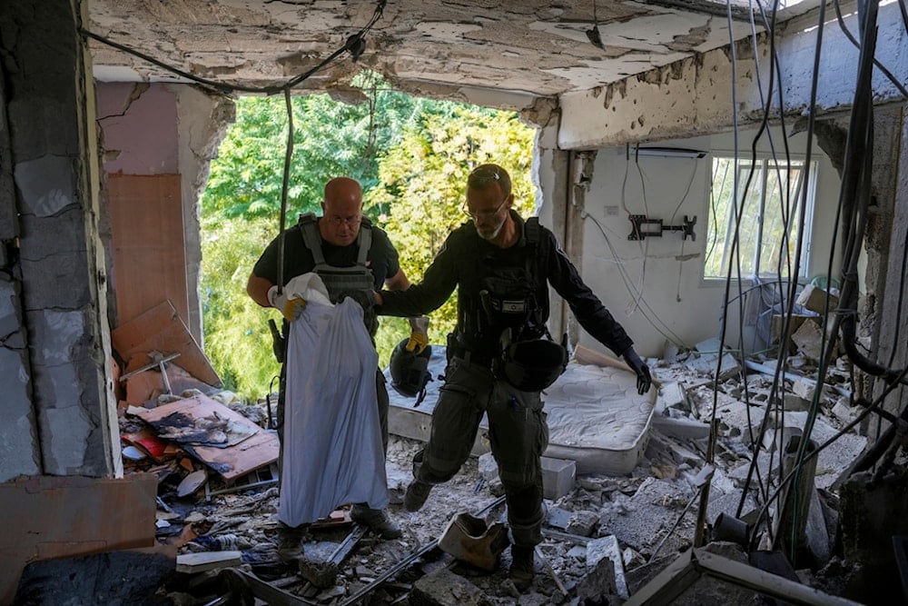 Israeli occupation police at the site where a rocket fired from Lebanon hit a residential building in Kiryat Shmona, in northern occupied Palestine, Wednesday, Nov. 20, 2024. (AP)