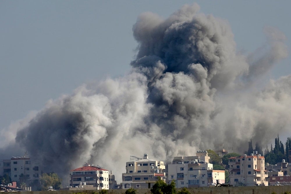 Smoke rises between buildings hit in an Israeli airstrike in Burj al-Shamali village, as seen from Tyre city, south Lebanon, Friday, Nov. 22, 2024. (AP)