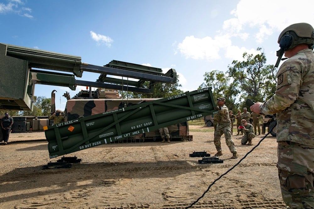 A US Army Staff Sargent adjusts the Army Tactical Missile System (ATACMS) for loading on to the High Mobility Artillery Rocket System (HIMARS) at Williamson Airfield in Queensland, Australia, on July 26, 2023  (AP)