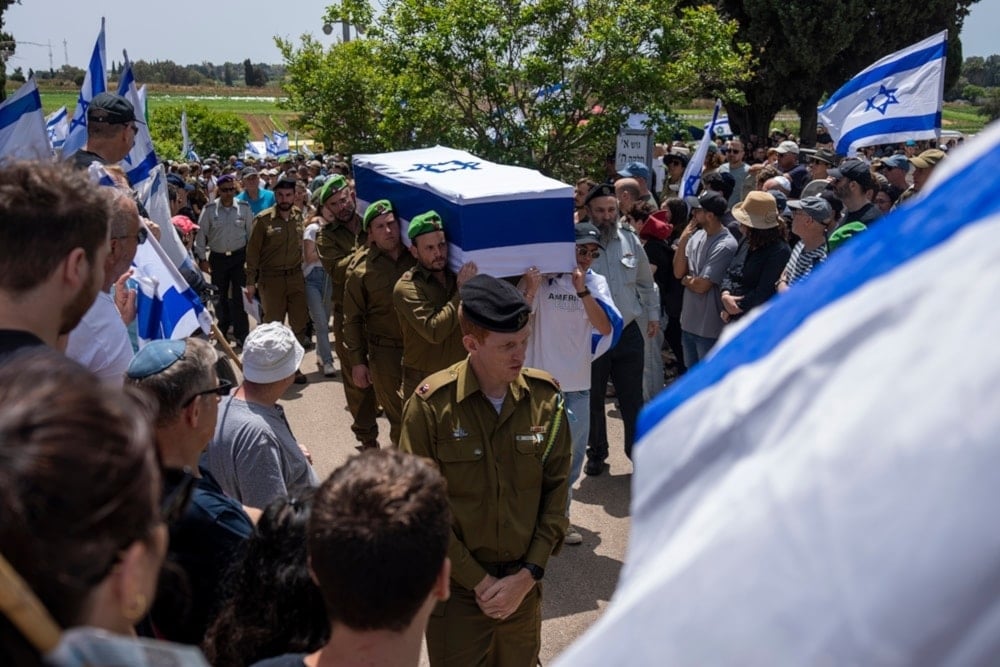 Israeli soldiers carry the casket of Israeli reserve Major Dor Zimel during his funeral in Even Yehuda, occupied Palestine, April 22, 2024. (AP)