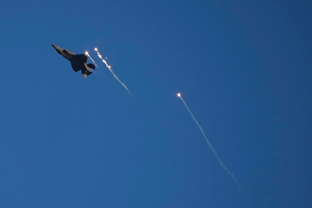 An Israeli air force F-35 war plane releases flares into the air in Hatzerim air force base near the southern occupied city of Bir al-Sabe, occupied Palestine, Thursday, June 23, 2022 (AP)