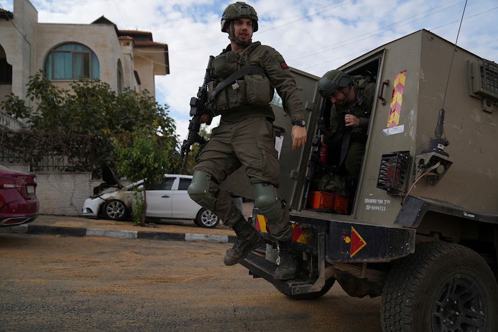 Israeli army investigators arrive at the site of the early morning attack of Israeli settlers, that left at least 18 burnt vehicles, on the outskirts of the West Bank city of al-Bireh on November 4, 2024. (AP)