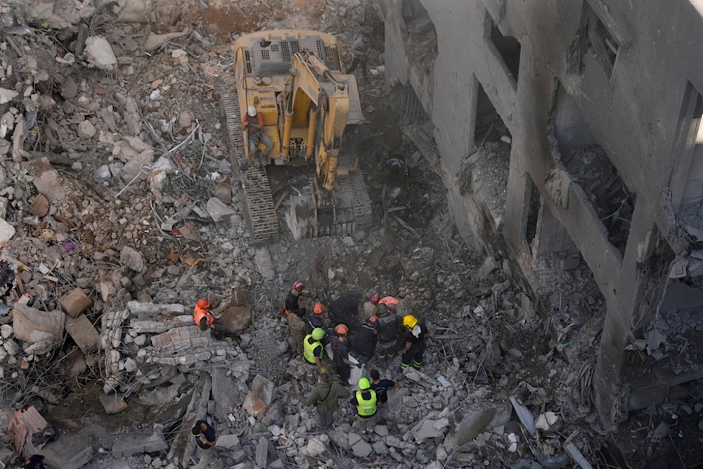 Rescue workers search for victims at the site of an Israeli occupation airstrike that hit central Beirut, Lebanon, Saturday, Nov. 23, 2024. (AP)